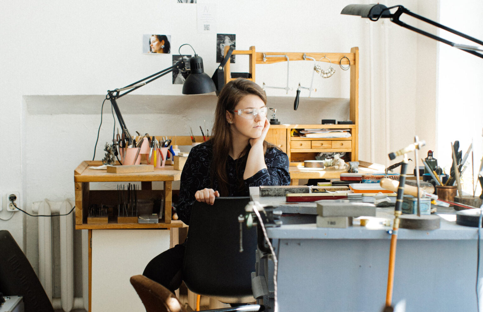 Woman sitting in her jewellrey design studio working on her Brix + Bailey collection