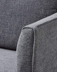 Grey fabric armchair with curved arms, modern design, and plush upholstery for stylish living room seating by sostter at brixbailey.com