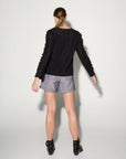 Luxury black ruffled blouse with lace inserts, puff sleeves, and romantic eyelet fabric, best-selling edgy romantic top by GILD at brixbailey.com