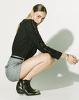 Luxury black ruffled blouse with lace inserts, puff sleeves, and eyelet fabric, stylish and romantic by GILD at brixbailey.com