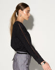 Luxury black ruffled blouse with eyelet fabric, puff shoulders, and lace inserts, edgy romantic top by GILD at brixbailey.com