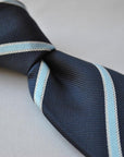 navy blue tie with light blue and white ribbon stripes