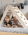 foldable montessori climbing triangle in use by toddler, set at 20.08 height for compact play