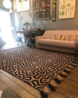 Premium monochrome flat weave wool rug, handmade in India, stylish geometric design with tassels, luxury neutral tones, best-selling by Maria Starling Design at brixbailey.com