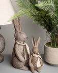 Handcrafted winter bunny rabbit resin figurine in warm brown, sitting pose with lifelike details, perfect for home decor. by Sostter at brixbailey.com