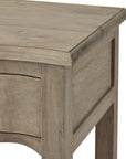 Handcrafted French provincial side table with hardwood construction, bleached finish, and black iron handles for rustic elegance. by Sostter at brixbailey.com