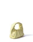 Bright yellow leather croissant handbag by Marshmallow, foldable evening bag at www.brixbailey.com