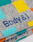 Colorful checkered socks, premium cotton blend, playful patterned design, elasticated comfort, best-selling unisex footwear, trending casual style by Body and I at brixbailey.com