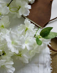 White artificial cherry blossom stem with cascading petals, 100 cm tall, perfect for spring floral arrangements.by Sostter at brixbailey.com