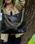Black Leather Crossbody Handbag with Metallic Accents