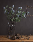 Artificial blue thistle stem with powder-blue petals and lifelike cone, perfect for rustic or coastal floral arrangements by sostter at brixbailey.com