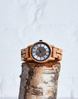 Luxury upcycled olive wood watch for men, handcrafted with exposed mechanics and glass back, showcasing natural grain patterns by The Sustainable Watch Company at brixbailey.com