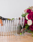 Silver champagne cooler with fluted metal body, leather handles, and mirror-polished finish for elegant entertaining by RoomLondon at brixbailey.com