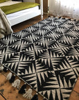 Premium monochrome flat weave wool rug, handmade in India, stylish geometric design with tassels, luxury neutral tones, best-selling by Maria Starling Design at brixbailey.com