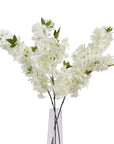 White plastic cherry blossom stem with cascading petals, 100 cm tall, ideal for spring floral arrangements.by Sostter at brixbailey.com