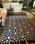 Luxury flat weave monochrome wool rug, handmade in India, stylish geometric design with tassels, best-selling contemporary ethnic decor by Maria Starling Design at brixbailey.com
