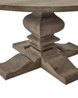Round pedestal dining table in bleached hardwood with black iron accents, warm brown tones, 150cm diameter. by Sostter at brixbailey.com