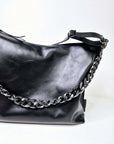 Black Leather Crossbody Handbag with Metallic Accents