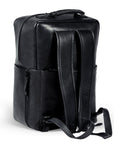 Premium black leather backpack for travel, handcrafted from recycled full-grain cowhide, durable eco-friendly design with antique brass hardware, spacious laptop compartment, trending adventure style by Bethikal at brixbailey.com