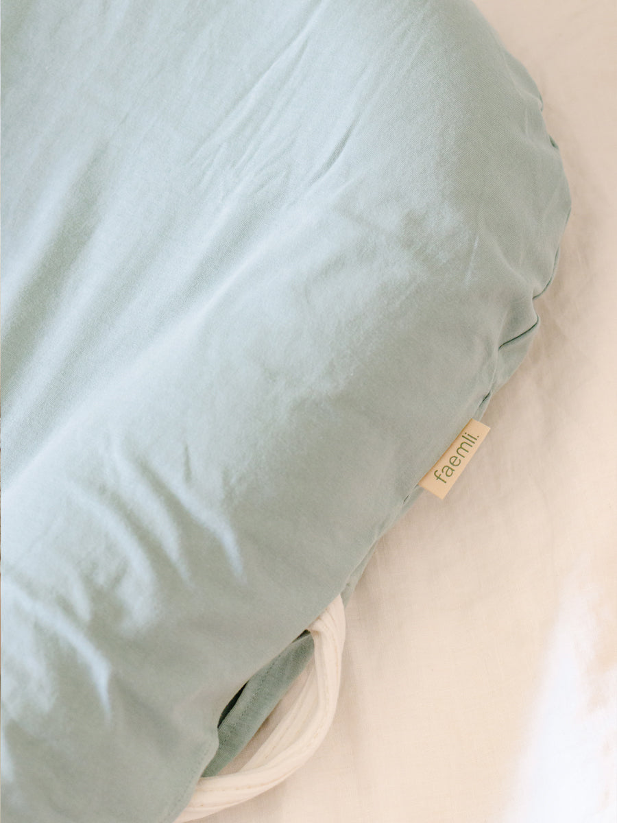 premium baby lounger, portable infant nest, soft and snug newborn lounger, best-selling tencel baby nest, stylish organic cotton baby lounger by Faemli at brixbailey.com