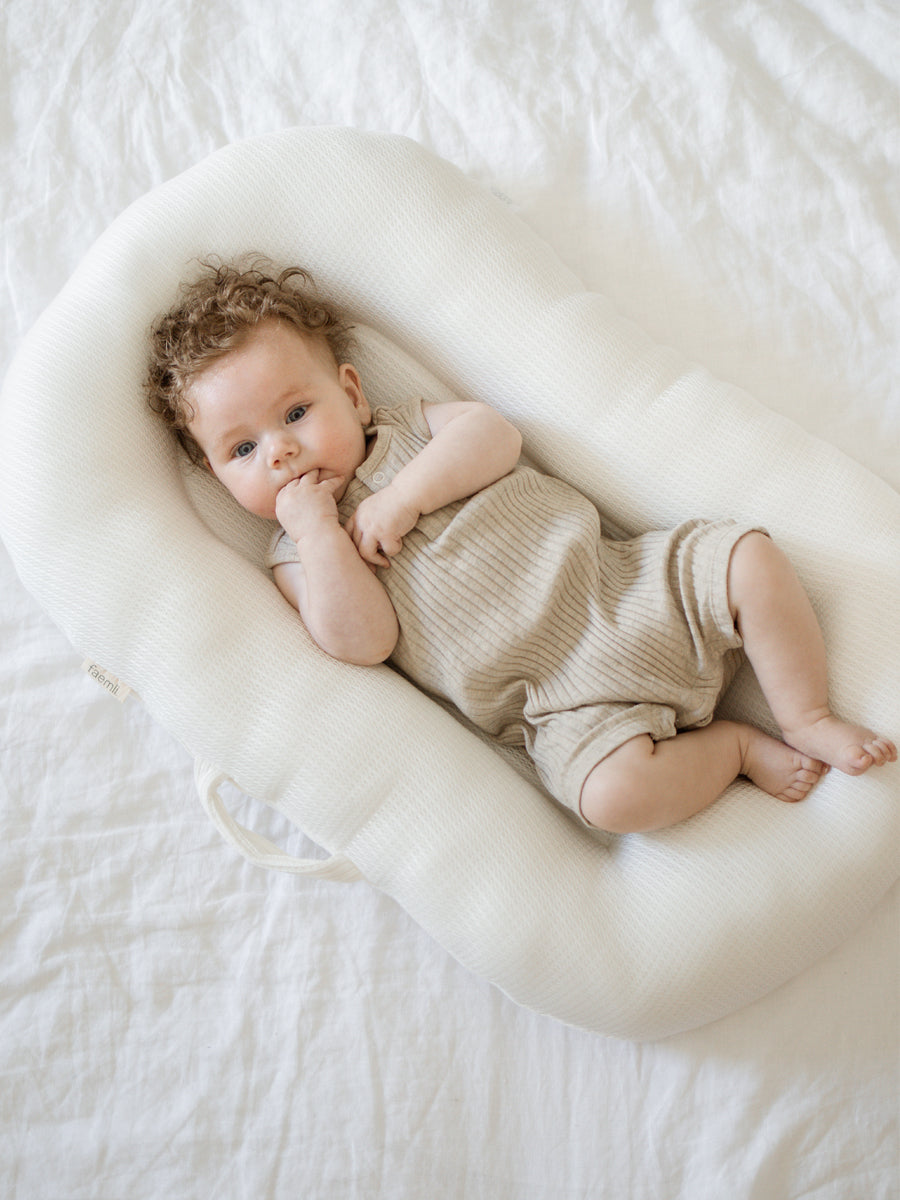 premium baby lounger, portable infant nest, soft organic cotton and tencel, best-selling newborn lounger for tummy time and reflux relief by Faemli at brixbailey.com