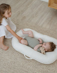 premium baby lounger, portable infant nest, soft and snug newborn lounger, best-selling tencel fiber baby nest, stylish and safe tummy-time lounger by Faemli at brixbailey.com