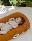 premium baby lounger, portable infant nest, soft and snug newborn lounger, best-selling tencel baby nest, stylish organic cotton baby bed by Faemli at brixbailey.com