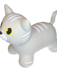 a playful grey cat jumpy toy bouncing on a sunny lawn with a child laughing nearby