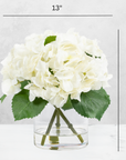 Faux hydrangea centerpiece arrangement in glass vase