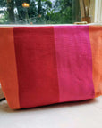 Premium British-made red orange pink toiletry bag, stylish herringbone stripes, waterproof lining, organic cotton, 8-inch compact zip pouch by Maison Elhoria at brixbailey.com