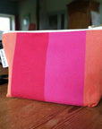 Premium British-made zip toiletry bag, red orange pink, compact 8 inch, organic cotton, waterproof lining, herringbone stripes by Maison Elhoria at brixbailey.com