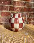 Checkered ceramic pitcher