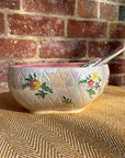 Floral salad bowl, with serving utensils