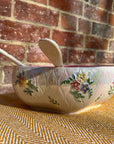 Floral salad bowl, with serving utensils