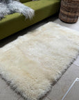 Premium British white curly sheepskin rug, luxury natural ivory fur, soft plush 90cm x 150cm, sustainable handcrafted free-range wool by Wildash London at brixbailey.com