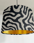 Black wiggle drum lampshade/ ceiling shade with a metallic brushed gold lining
