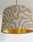 Ecru wiggle drum lampshade/ ceiling shade with a metallic brushed gold lining