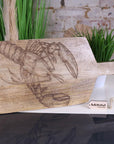 Luxury handcrafted fish serving platter board, premium mango wood with intricate lobster or fish engraving, stylish coastal kitchenware by Maravi at brixbailey.com
