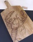 Luxury handcrafted lobster and fish serving platter board, premium mango wood with intricate coastal engravings, stylish kitchenware by Maravi at brixbailey.com