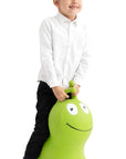 confident toddler jumping high on a bright green wormy hopper toy indoors