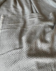 Premium Noble Cashmere Blanket, handwoven in Nepal, 100% pure cashmere, luxury herringbone throw, soft grey, oversized 125x250cm by Wildash London at brixbailey.com