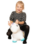 confident toddler bouncing on a vibrant unicorn hopper toy indoors
