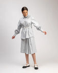 Luxury oversized ice blue shirt with tie-up detailing, upcycled cotton linen, comfortable fit, handcrafted from factory waste by Bethikal at brixbailey.com