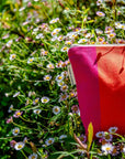 Premium British-made zip toiletry bag, red orange pink herringbone stripes, organic cotton, waterproof lining, compact 8 inches by Maison Elhoria at brixbailey.com
