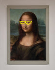 Luxury Mona Lisa Glasses Framed Print, stylish modern twist on classic art, premium home decor, trending best-selling artwork by Zestio at brixbailey.com