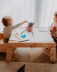 kids playing with paper roll with table holder