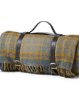 Roll-up picnic blanket with leather straps on a white background sold on Brix + Bailey