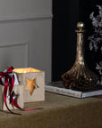 Handcrafted whitewashed wooden star tealight holder with natural grain, casting warm glow patterns for cozy decor. by RoomLondon at brixbailey.com