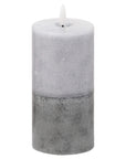 Premium LED candle with realistic flicker in natural stone finish, handcrafted two-tone design, warm amber glow by Sostter at brixbailey.com