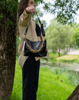 Black Leather Handbag with Metallic Straps